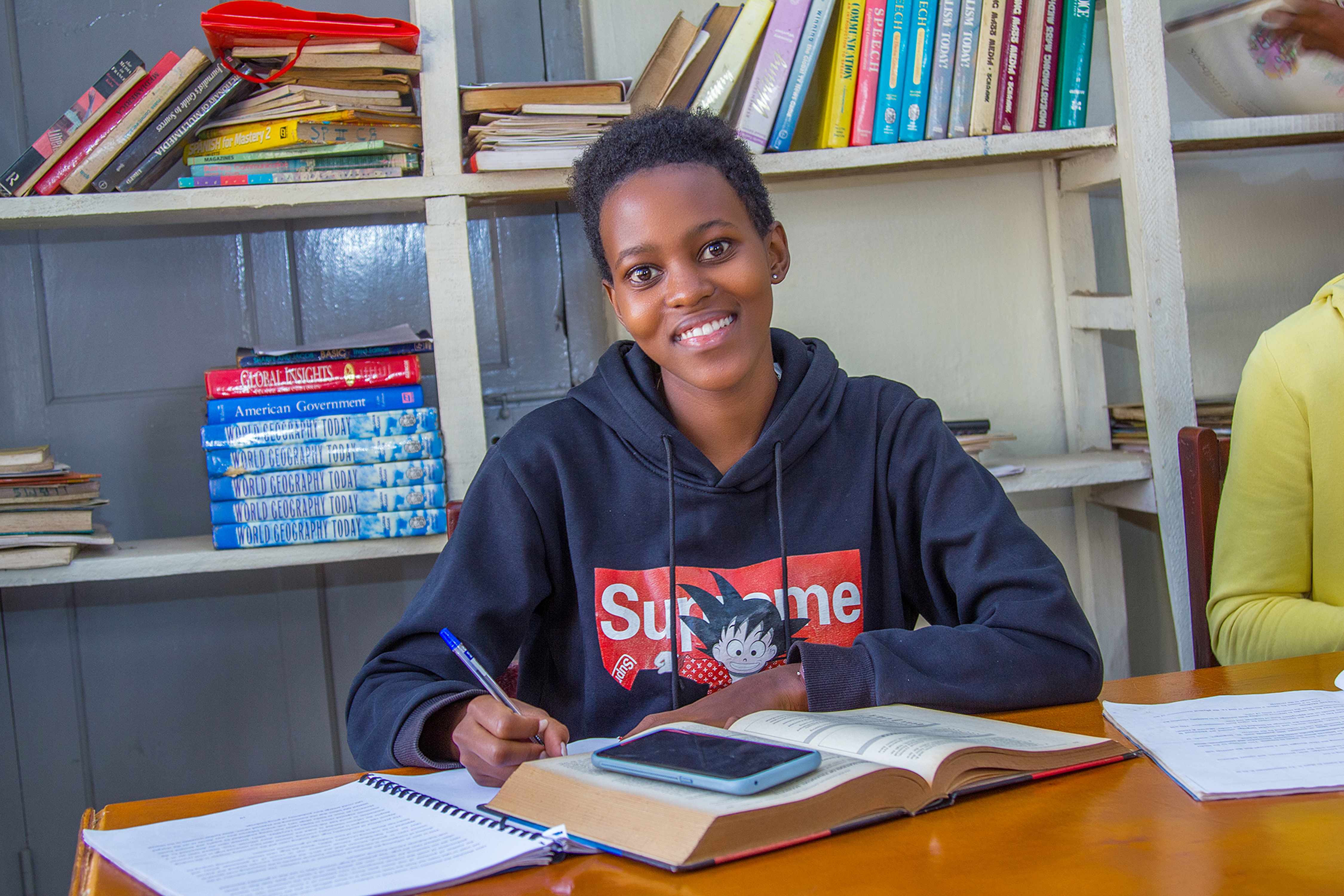 Student writing in the library